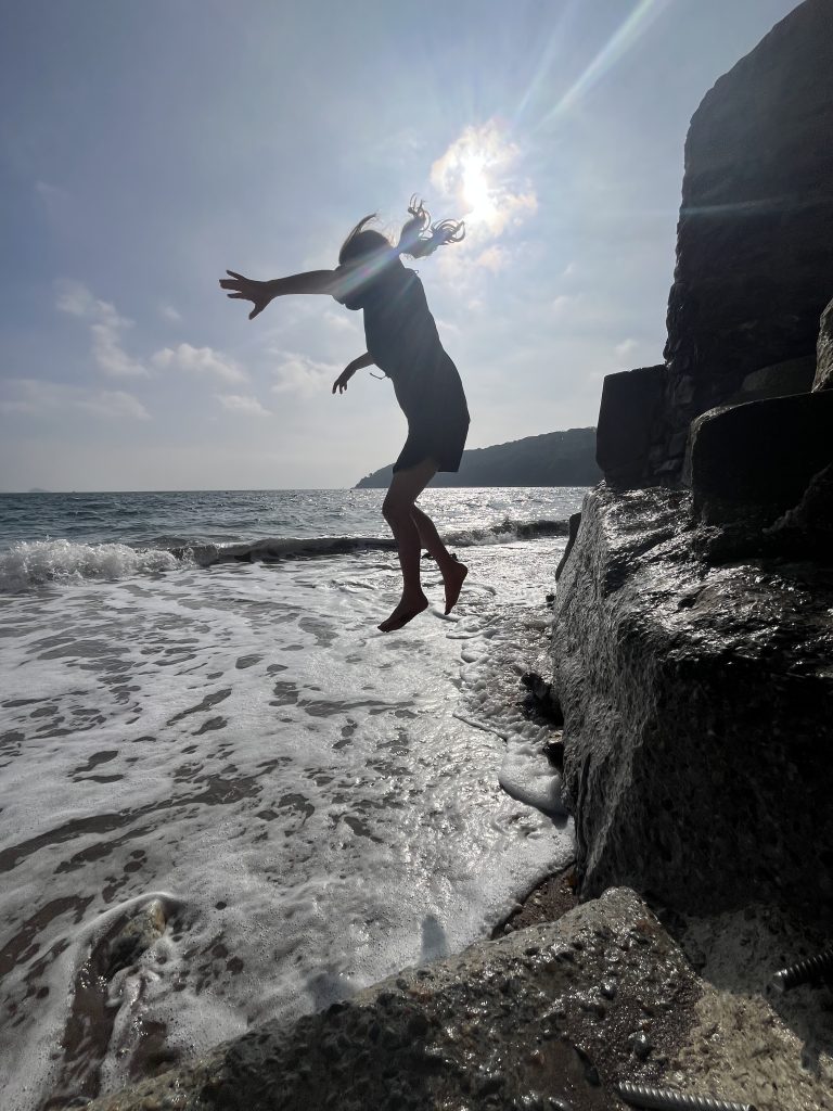 Jumping down on to the beach at Kingsand
